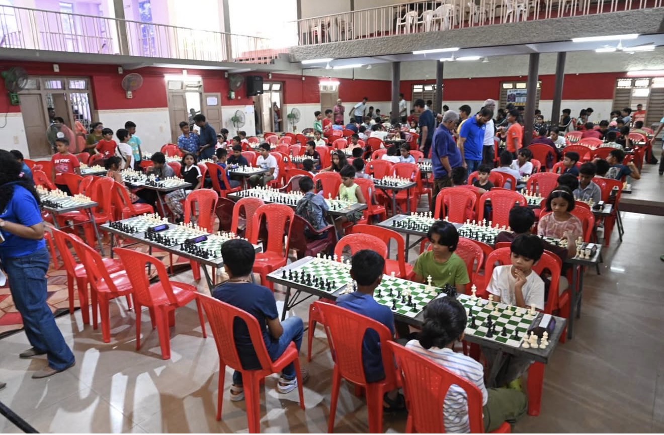 Wide view of the Champions Gambit Season 1 tournament hall full of young players